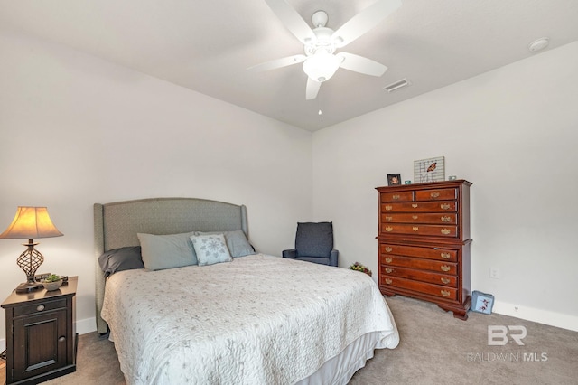 bedroom featuring baseboards, visible vents, ceiling fan, and light colored carpet