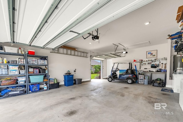 garage with a garage door opener and electric water heater