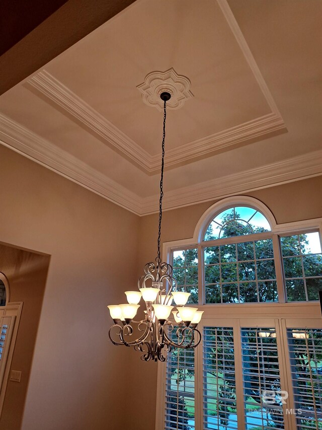 living room with coffered ceiling, ceiling fan with notable chandelier, beam ceiling, hardwood / wood-style flooring, and decorative columns