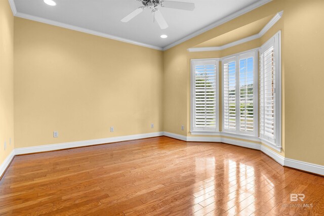 empty room with light hardwood / wood-style flooring, ceiling fan, and crown molding