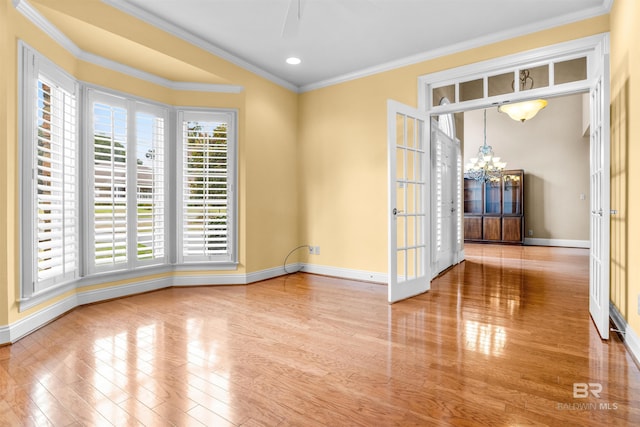 unfurnished room featuring ornamental molding, hardwood / wood-style floors, and a healthy amount of sunlight