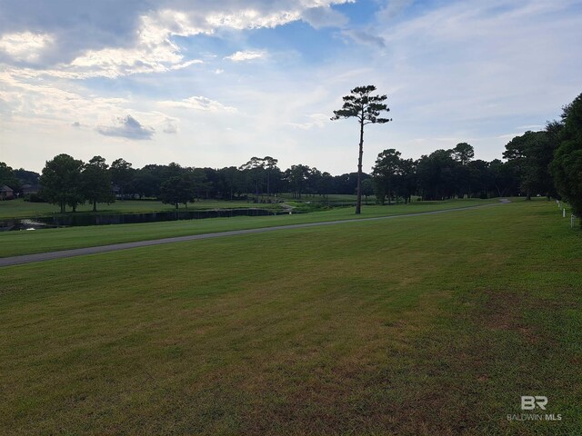 view of community with a lawn and a water view