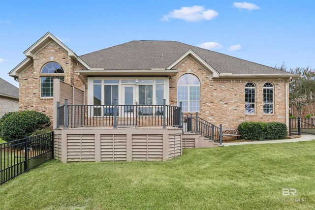 view of front of home with a front yard and a deck