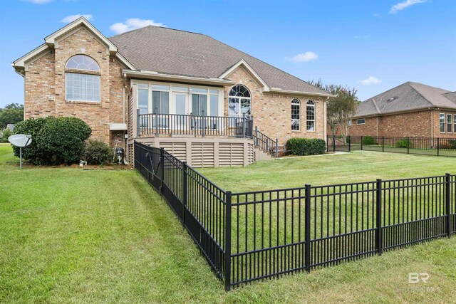 back of house featuring a yard