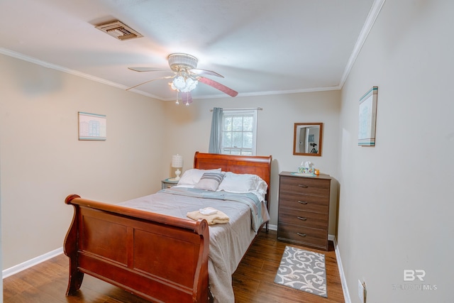 bedroom featuring ceiling fan, dark hardwood / wood-style flooring, and crown molding