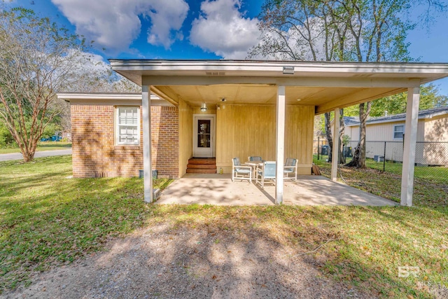 rear view of house with a yard and a patio