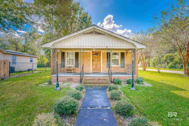 bungalow-style house with covered porch and a front lawn