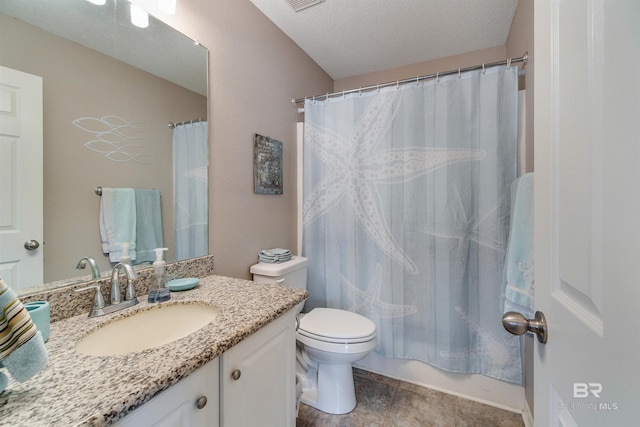 bathroom featuring vanity, toilet, and a textured ceiling