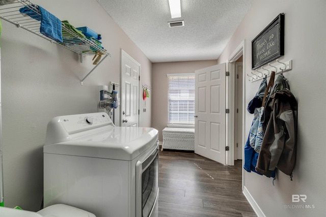 laundry room with dark hardwood / wood-style flooring, washer / dryer, and a textured ceiling