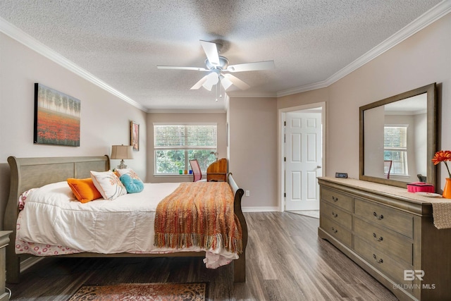 bedroom featuring hardwood / wood-style floors, a textured ceiling, ornamental molding, and ceiling fan