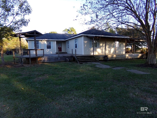 rear view of property with a lawn and a wooden deck