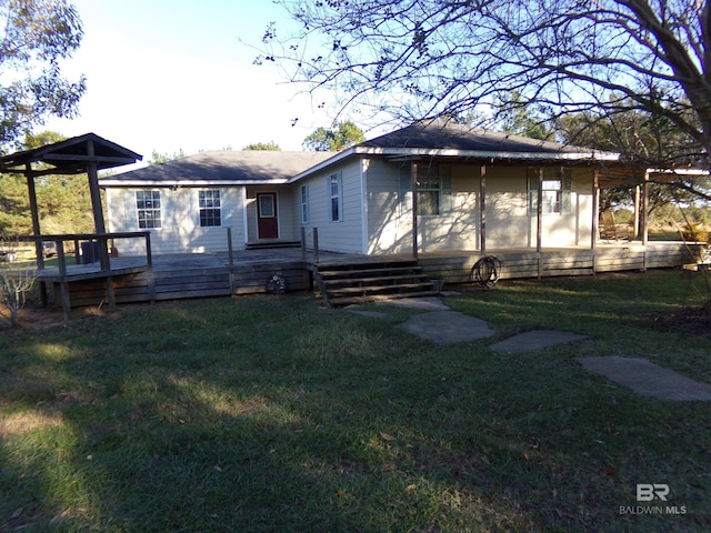 back of house featuring a deck and a yard