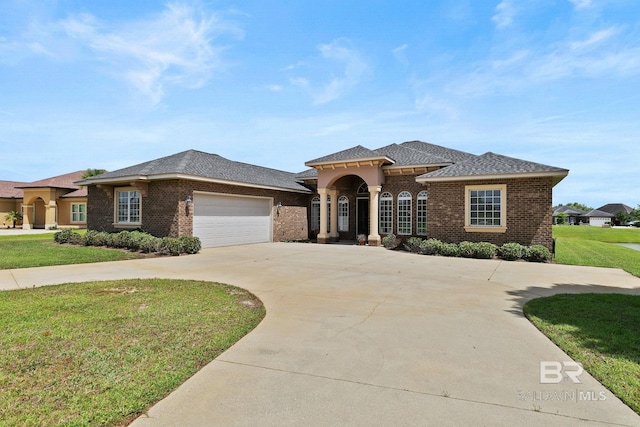 view of front of property with a garage and a front lawn