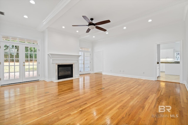 unfurnished living room featuring french doors, ceiling fan, crown molding, and light hardwood / wood-style floors