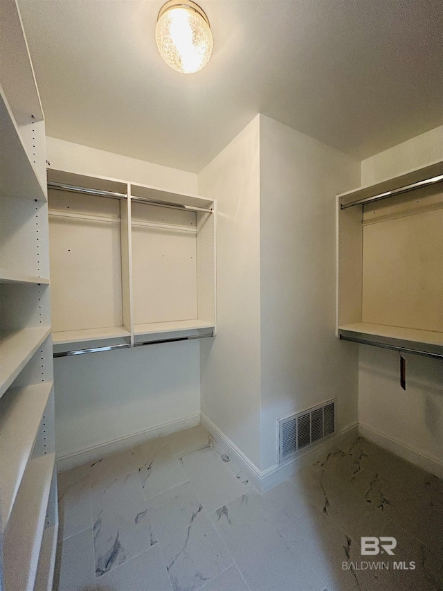 2613 Charlotte Oaks Dr, Mobile, AL 36695 - spacious closet featuring marble look tile flooring