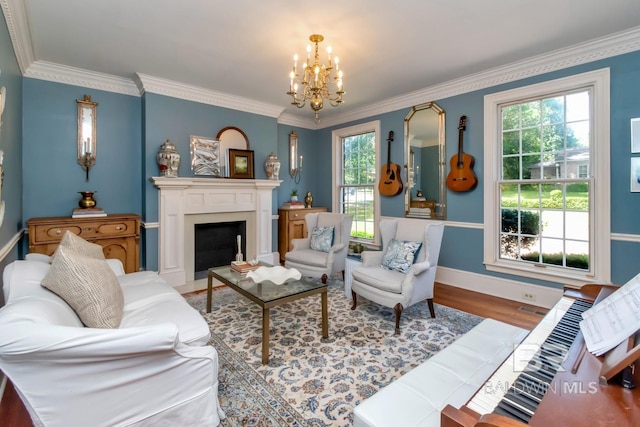 41 Yester Pl, Mobile, AL 36608 - living room with an inviting chandelier, wood finished floors, crown molding, and a fireplace with flush hearth