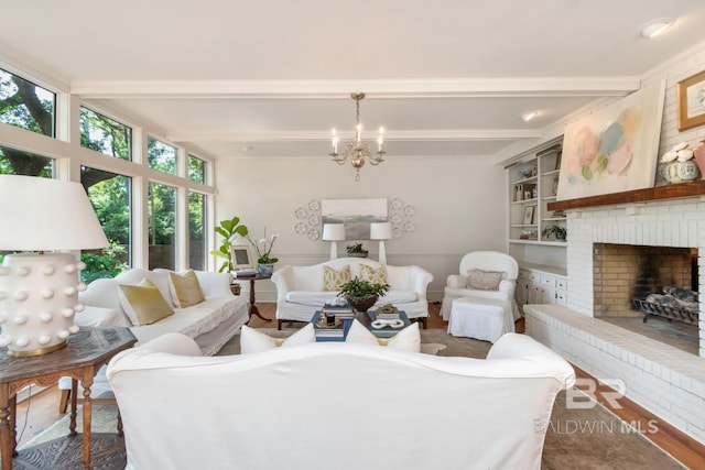 41 Yester Pl, Mobile, AL 36608 - living room featuring beamed ceiling, an inviting chandelier, and a brick fireplace