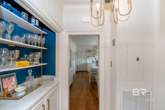 41 Yester Pl, Mobile, AL 36608 - interior space featuring a chandelier, wood finished floors, electric panel, and crown molding