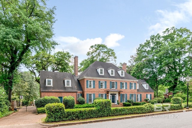 41 Yester Pl, Mobile, AL 36608 - view of front of house with a gate, brick siding, and a chimney