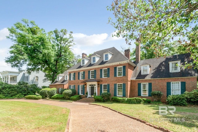 41 Yester Pl, Mobile, AL 36608 - colonial-style house with a chimney, brick siding, and a front lawn