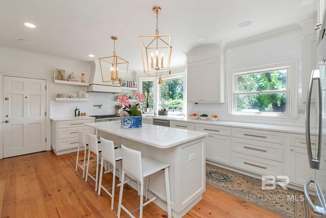 41 Yester Pl, Mobile, AL 36608 - kitchen featuring a healthy amount of sunlight, open shelves, white cabinets, and backsplash