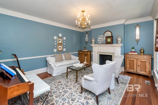 41 Yester Pl, Mobile, AL 36608 - living area featuring ornamental molding, an inviting chandelier, wood finished floors, and a fireplace
