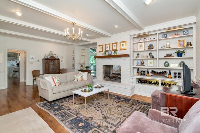 41 Yester Pl, Mobile, AL 36608 - living area featuring wood finished floors, a notable chandelier, beamed ceiling, and a fireplace