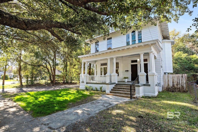 view of front of property featuring a porch and a front lawn