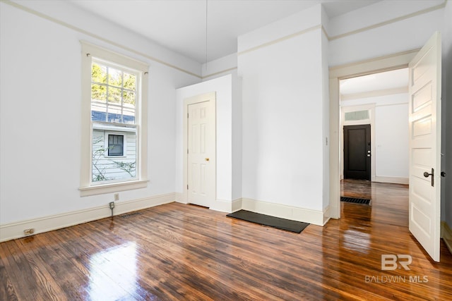 unfurnished room with dark hardwood / wood-style floors