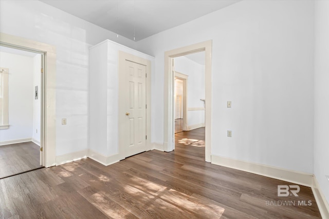 empty room with dark hardwood / wood-style floors