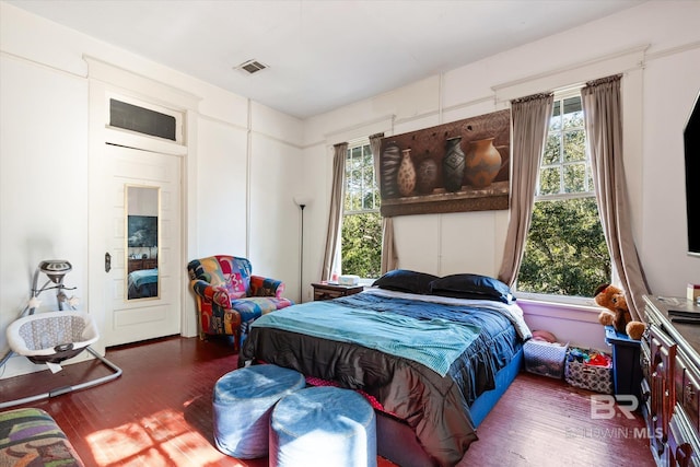 bedroom with dark wood-type flooring