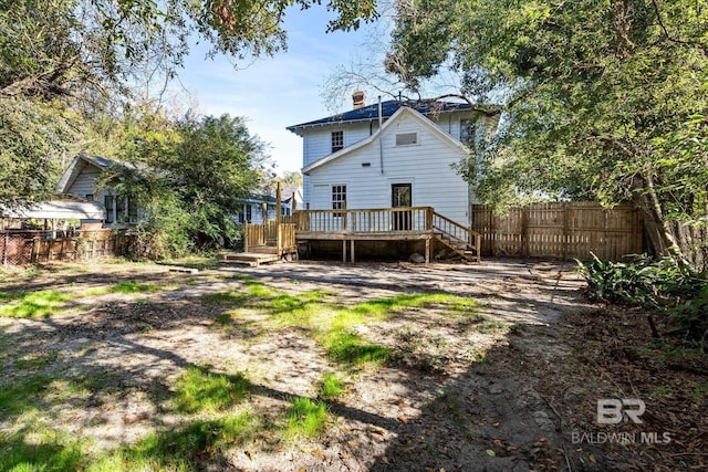 back of property with a wooden deck