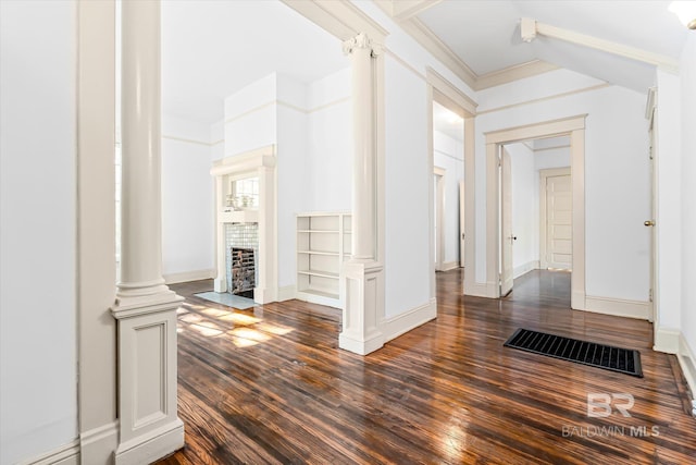 hall featuring ornate columns, crown molding, and dark hardwood / wood-style flooring