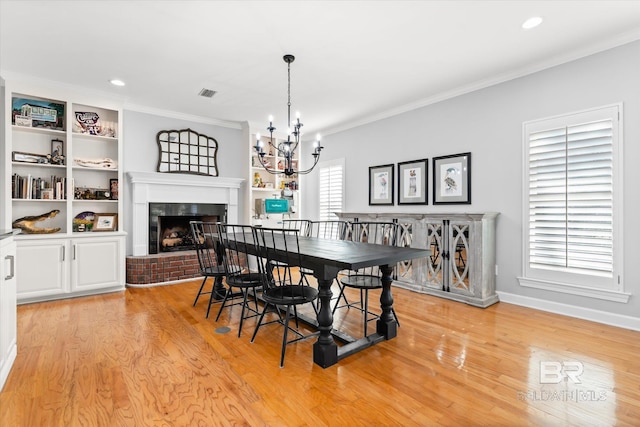 dining area with plenty of natural light, light hardwood / wood-style floors, and ornamental molding