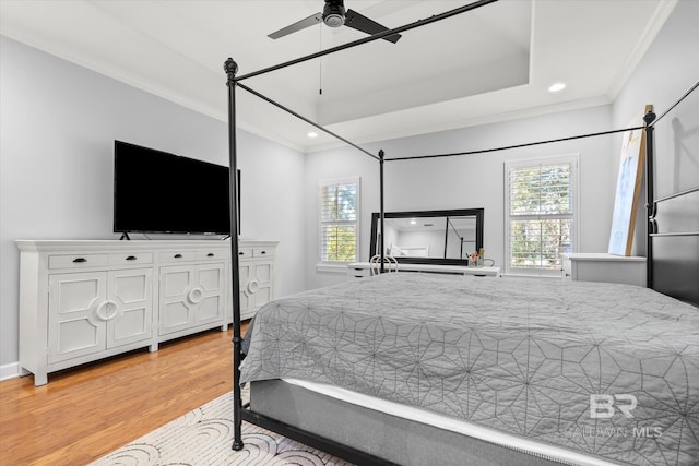 bedroom featuring light wood-type flooring, ceiling fan, and crown molding