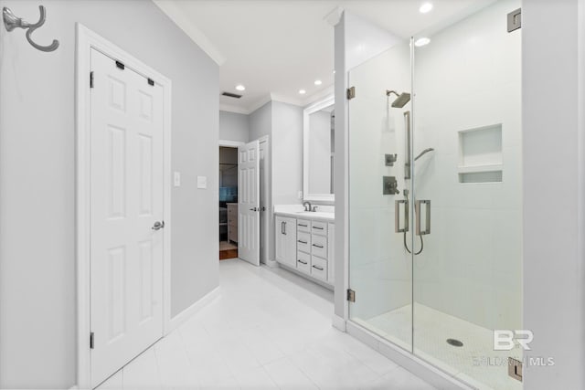 bathroom with crown molding, a shower with door, and vanity