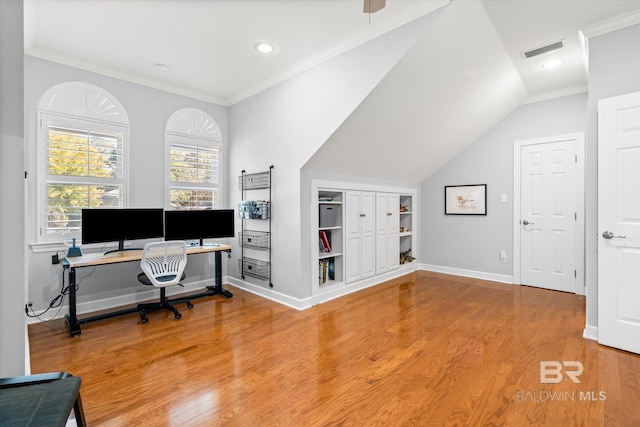 office space featuring crown molding, vaulted ceiling, and hardwood / wood-style flooring