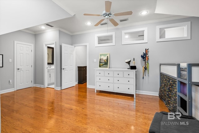 bedroom with ensuite bathroom, ceiling fan, light wood-type flooring, and crown molding