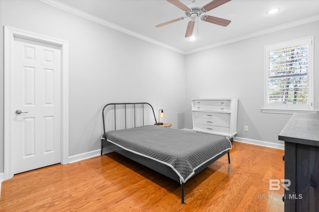 bedroom with ceiling fan, ornamental molding, and light hardwood / wood-style flooring