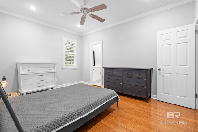 bedroom featuring ceiling fan, ensuite bathroom, ornamental molding, and light wood-type flooring