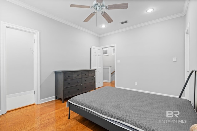 bedroom featuring ceiling fan, ornamental molding, and light hardwood / wood-style flooring