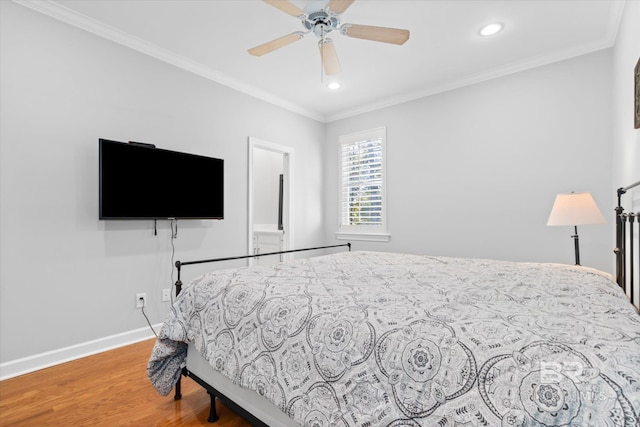 bedroom featuring ceiling fan, crown molding, and wood-type flooring