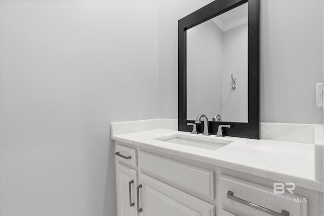 bathroom featuring crown molding and vanity