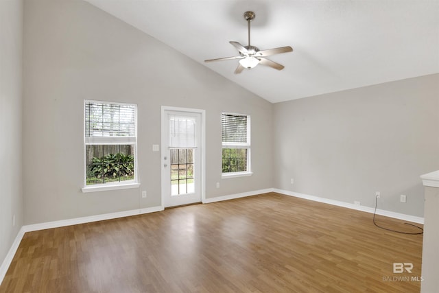 unfurnished room with ceiling fan, plenty of natural light, baseboards, and wood finished floors