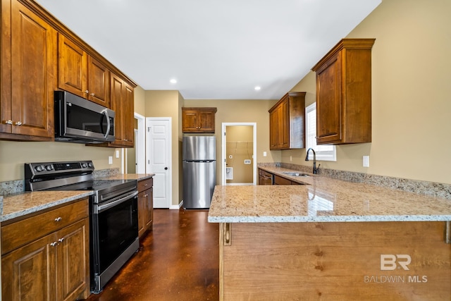 kitchen featuring sink, light stone counters, stainless steel appliances, and kitchen peninsula