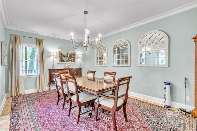 dining area with baseboards, an inviting chandelier, and crown molding