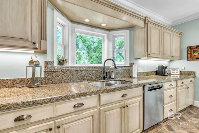 kitchen featuring light stone countertops, stainless steel dishwasher, a sink, and crown molding