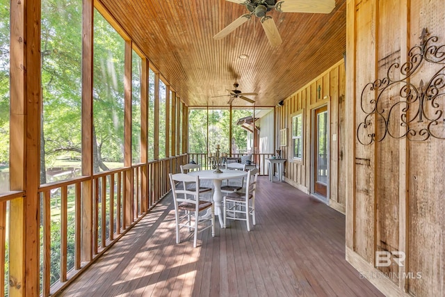 sunroom / solarium featuring ceiling fan and outdoor dining area