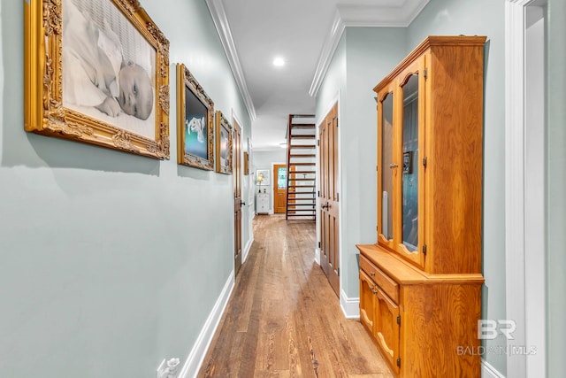 hall featuring baseboards, ornamental molding, wood finished floors, and recessed lighting