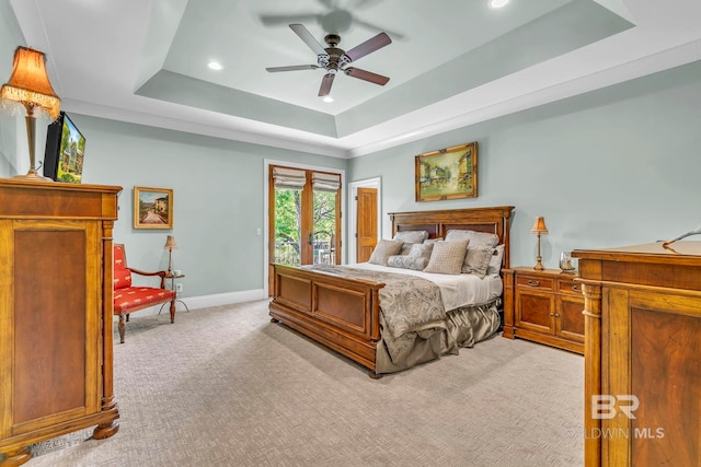 bedroom featuring recessed lighting, a raised ceiling, light carpet, and access to outside
